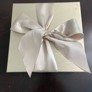 Gold Macy’s box and gold ribbon.